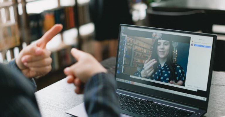 Maori Language - Young lady learning sign language during online lesson with female tutor
