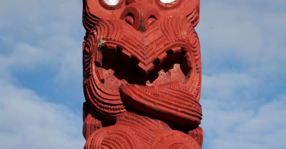 Maori Sites - Red Maori Totem Pole against Blue Sky