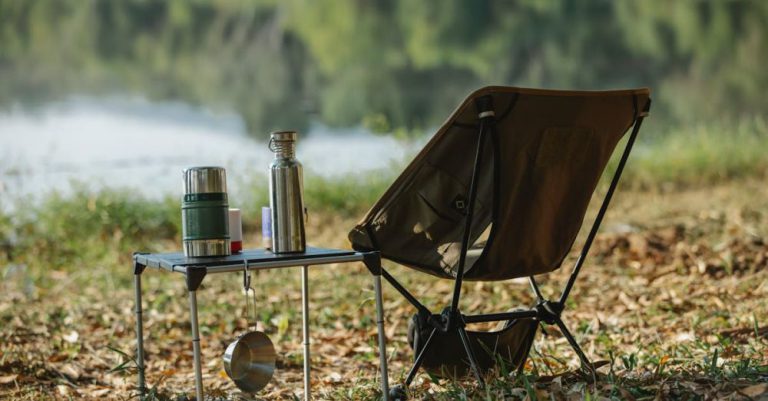 Lakeside Camping - Camping chair near table on river shore