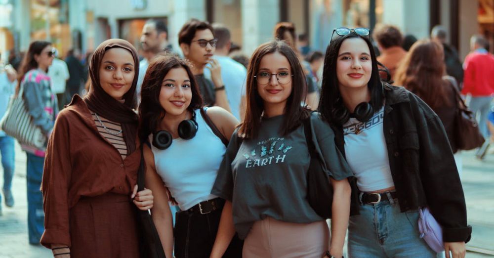 Eco-Tourism - Four women standing on a street with a man