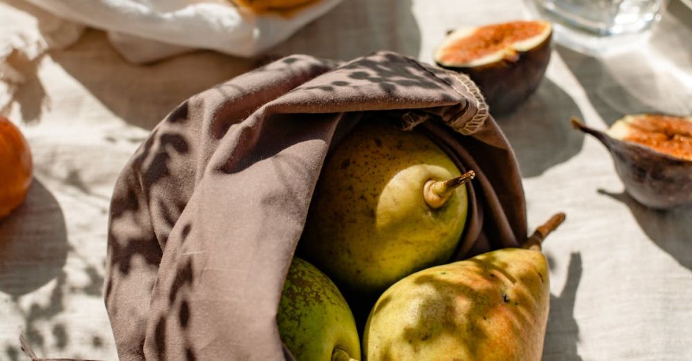 Eco-Friendly - Bags with Fresh Fruits and a Glass of Water Standing in Sunlight