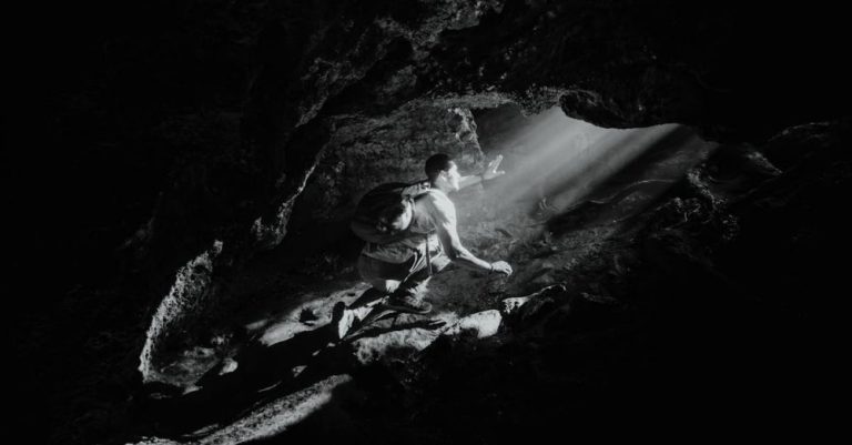 Caving - Backpacker Exploring a Cave
