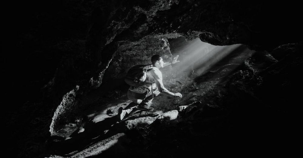 Caving - Backpacker Exploring a Cave