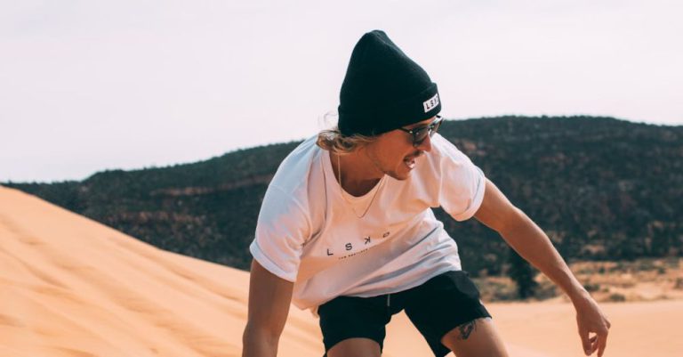 Sandboarding - A Man in White Shirt