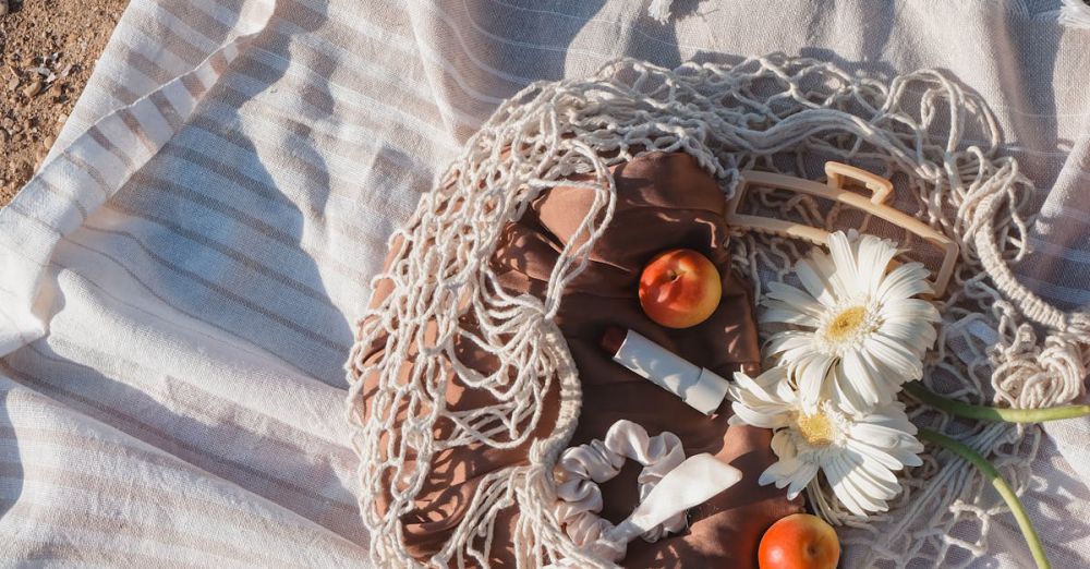 Beach Picnics - A book, a blanket and a basket of fruit on a beach