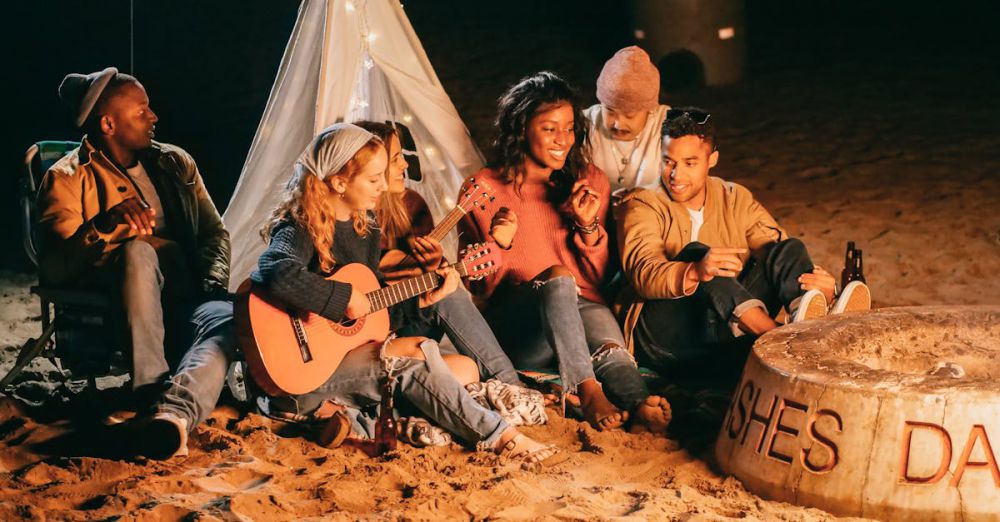 Beach Bonfires - Group of Friends Sitting on Beach Sand