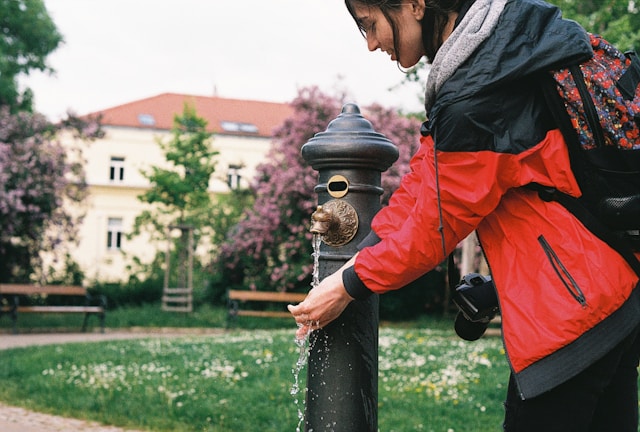 a-woman-standing-next-to-a-fire-hydrant