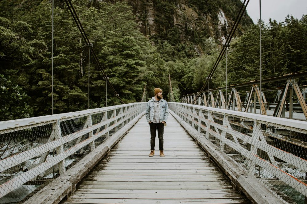 man-on-wooden-bridge-Milford Sound
